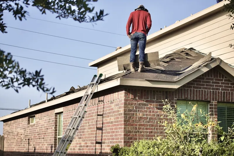 Professional roofer working on a residential roof in Neshaminy Falls